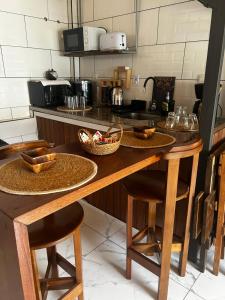 a kitchen with a wooden table with two stools at Hospedaje Rivera Chico in Rivera