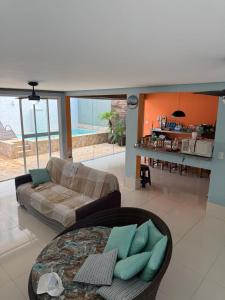 a living room with a couch and a table at Casa em Condomínio in Bertioga