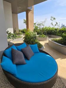 a blue couch with pillows on a patio at Trizen OceanView in Colombo