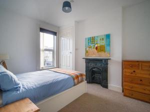 a bedroom with a bed and a fireplace and a window at The Red Door in Bangor +21 photos