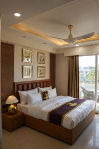 a bedroom with a large bed with a ceiling fan at Five Palms Hotel in Gurgaon +83 photos
