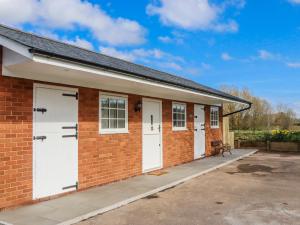 a brick building with four white garage doors at Shamrock in Exeter
