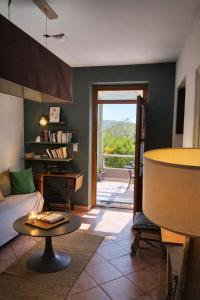 a living room with a couch and a table at La Maison De Stephanie in Porto-Vecchio