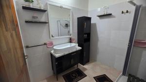 a bathroom with a sink and a mirror at Casa Grilla in Assemini