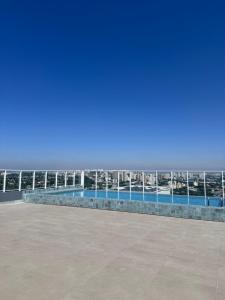 a swimming pool with a view of the city at Central Studio in the metro Butantã in São Paulo