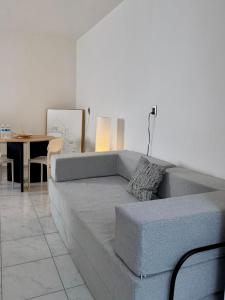 a living room with a gray couch and a table at Belisario Apartment in Ocotlán