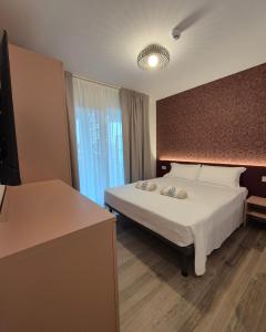 a hotel room with a bed and a window at Libra Aparthotel in Bibione +68 photos