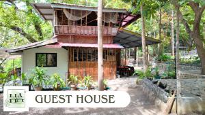 a guest house with a sign that reads guest house at Hangin at Agos Resort in Nasugbu