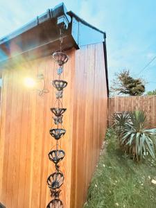 a fence with four wine glasses on it at Golden Oak Guest House in North Leigh +9 photos