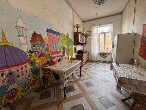 a kitchen with a painting on the wall at Nomads Nest in Kutaisi