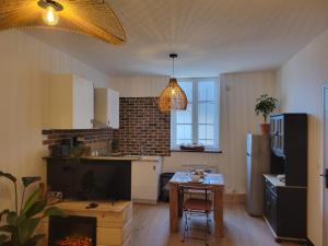 a kitchen with a table and a kitchen with a dining room at studio Anémos in Fécamp