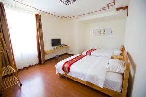 En eller flere senger på et rom på Han Shu Xiang Yuan Hostel