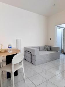 a living room with a couch and a table and chairs at Belisario Apartment in Ocotlán