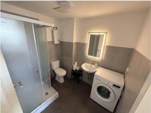 a bathroom with a washing machine and a sink at CityNest Apartment Dortmund in Dortmund