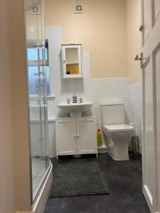 a bathroom with a sink and a toilet at 18b Sandamar in Sutton on Sea +5 photos