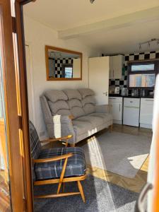 a living room with a couch and a chair at g11 chalet in Mablethorpe