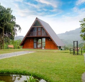 a large wooden building with a pitched roof at 8 Acres Tea Escape in Deniyaya