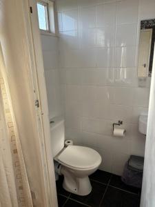 a white bathroom with a toilet and a window at g11 chalet in Mablethorpe