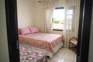 a small bedroom with a bed and a window at Hostel e Pousada Vó Lili in Joinville +17 photos