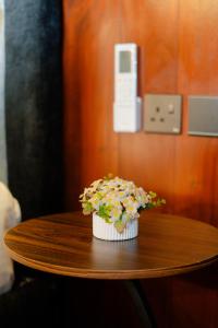 a cupcake with flowers on a wooden table at 8 Acres Tea Escape in Deniyaya