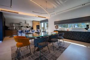a kitchen and dining room with a glass table and chairs at Luxury Seafront Villa Aman Korcula with Pool in Korčula