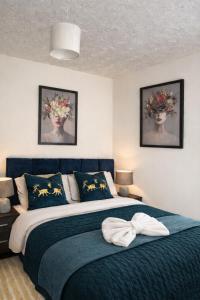 a bedroom with a large bed with a blue blanket at Large 4 bedroom house for Contractors, Large groups or Retreat sleeps 8 people in Durham - NO Smoking Indoor House in Edmondsley