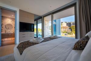 a bedroom with a large bed with a large window at Luxury Seafront Villa Aman Korcula with Pool in Korčula +41 photos