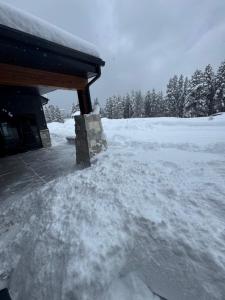 a pile of snow on the side of a house at Yellowstone Springs Resort in Island Park