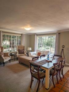 a living room with a table and a couch at Shepherd's Corner Guest House - Tranquil Boutique Stay in Bryanston in Johannesburg