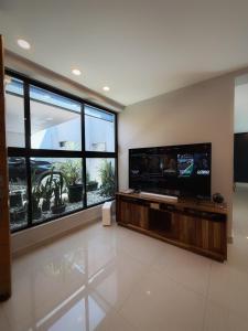 a living room with a large flat screen tv at "Casa Mosso" en San Felipe del Agua in Oaxaca City