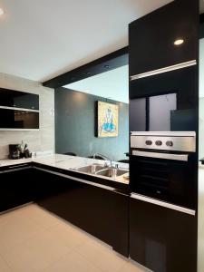 a kitchen with a sink and a stove at "Casa Mosso" en San Felipe del Agua in Oaxaca City