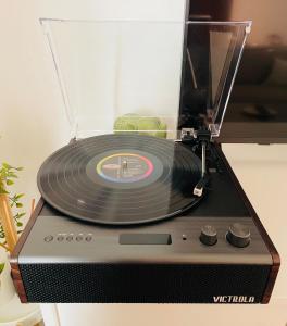 a record player with a vinyl record on top of it at Downtown Studio Free Parking 1 mi to Beach & Convention Center in Long Beach