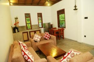 a living room with couches and a coffee table at Muraaya in Habaraduwa Central