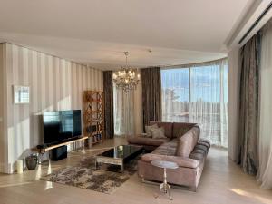 a living room with a couch and a television at Casa La Perla in Budva