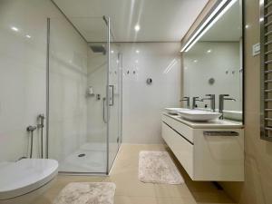 a bathroom with a shower and a sink and a toilet at Casa La Perla in Budva +10 photos