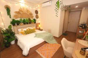 a bedroom with a bed in a room with plants at Sunleaf Studio Pari Chawk Expo Mart in Greater Noida +3 photos