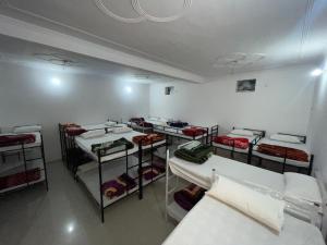 a room with a bunch of bunk beds in it at The rest point dormitory in Khātu +11 photos