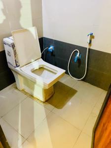 a bathroom with a white toilet in a room at The rest point dormitory in Khātu