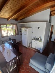 a kitchen and dining room with a refrigerator and a table at Departamento Independiente con Terraza in La Cieneguita