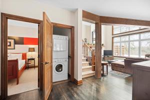 a kitchen and living room with a washer and dryer at Townhouse On The Golf La Bte -10min To Tremblant in Mont-Tremblant