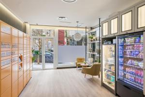 a grocery store with a large refrigerator and a table at B&B HOTEL Vigo in Vigo