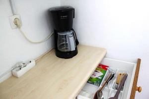a coffee maker sitting on top of a wooden counter at Nice house close to the sea in Mati