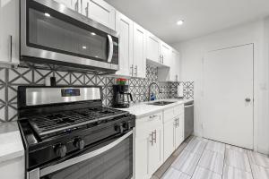 a kitchen with a stove and a microwave at Atlanta North Urban Chic 2BR- 7th Floor in Atlanta