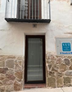a window on the side of a building with a balcony at El Encantodemora in Mora de Rubielos