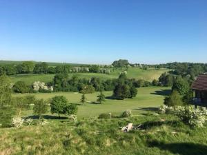 an overhead view of a green field with a house at la penombre spa in Abbeville +11 photos