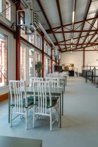 a dining room with a table and white chairs at Il Platano Guest House in Quartino