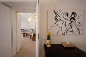 a living room with a drawing on the wall at Villa Oro in Oia