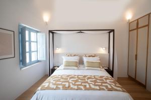 a bedroom with a large bed with two pillows at Villa Oro in Oia +26 photos