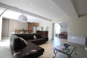 a living room with a couch and a table at Chez soule in Riupeyrous