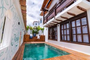 a house with a swimming pool and a patio at Condominio The monkey House in Villa de Leyva
